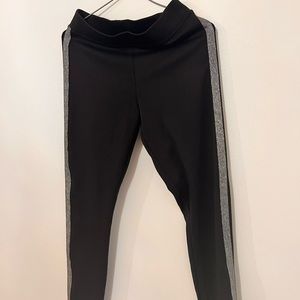 Black leggings with metallic detailing on the sides.